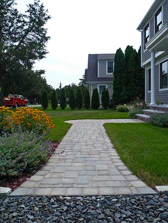 Stone driveway transitions into stone path to front door.