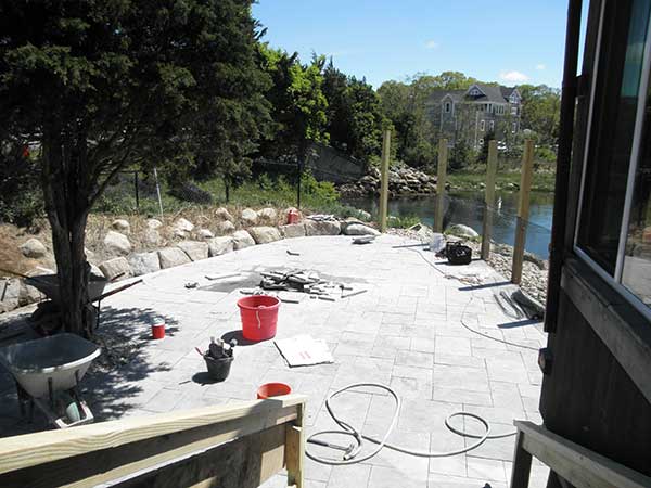 Stone seaside restaurant patio being installed.