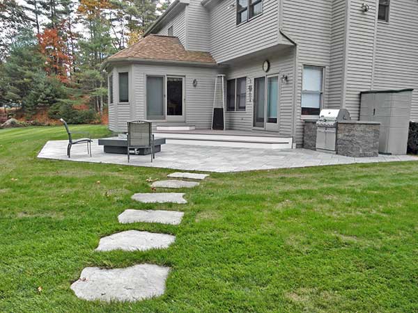 Backyard stone patio and stone walkway.
